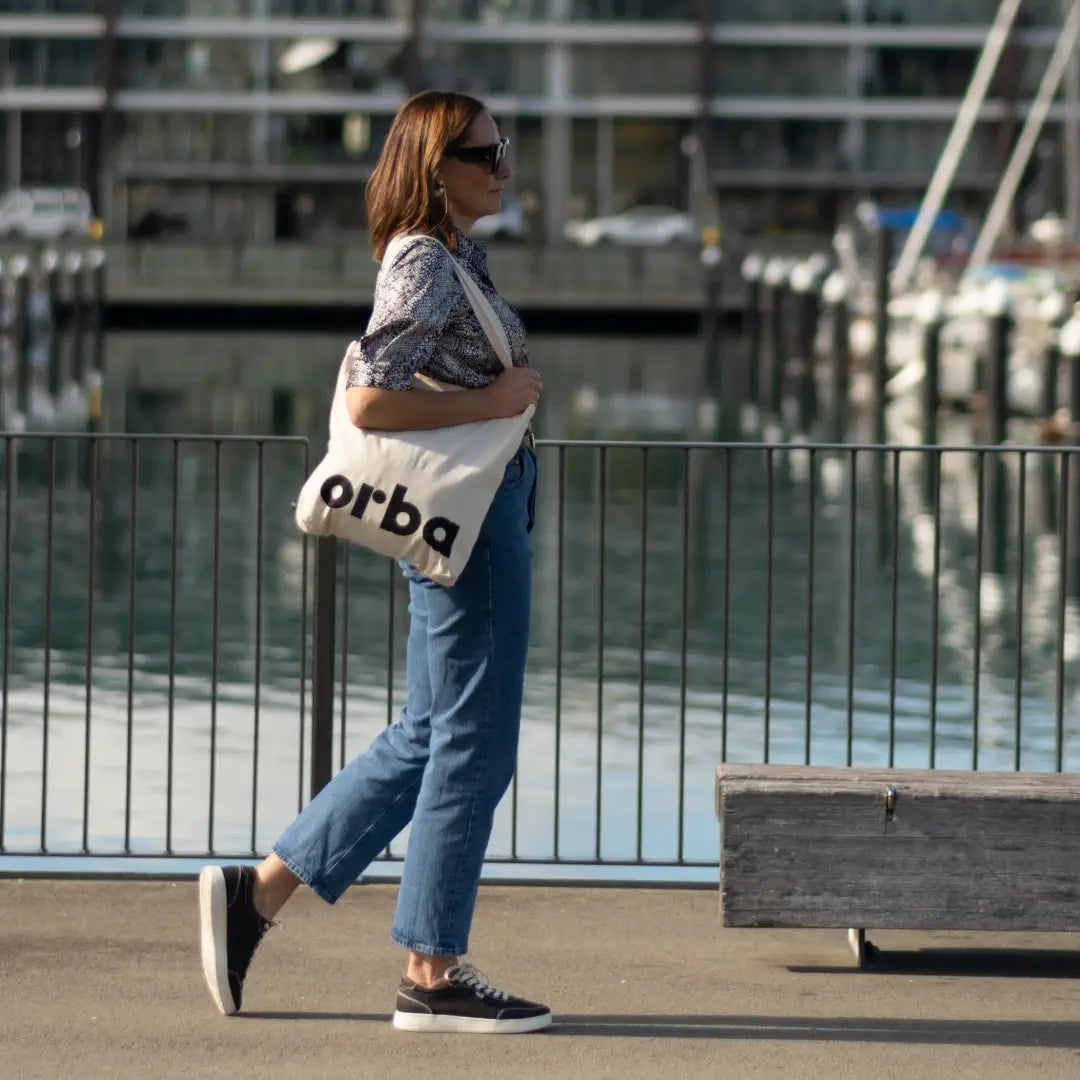 Women wearing Orba Ghost Black/ Off-white sneaker and totebag