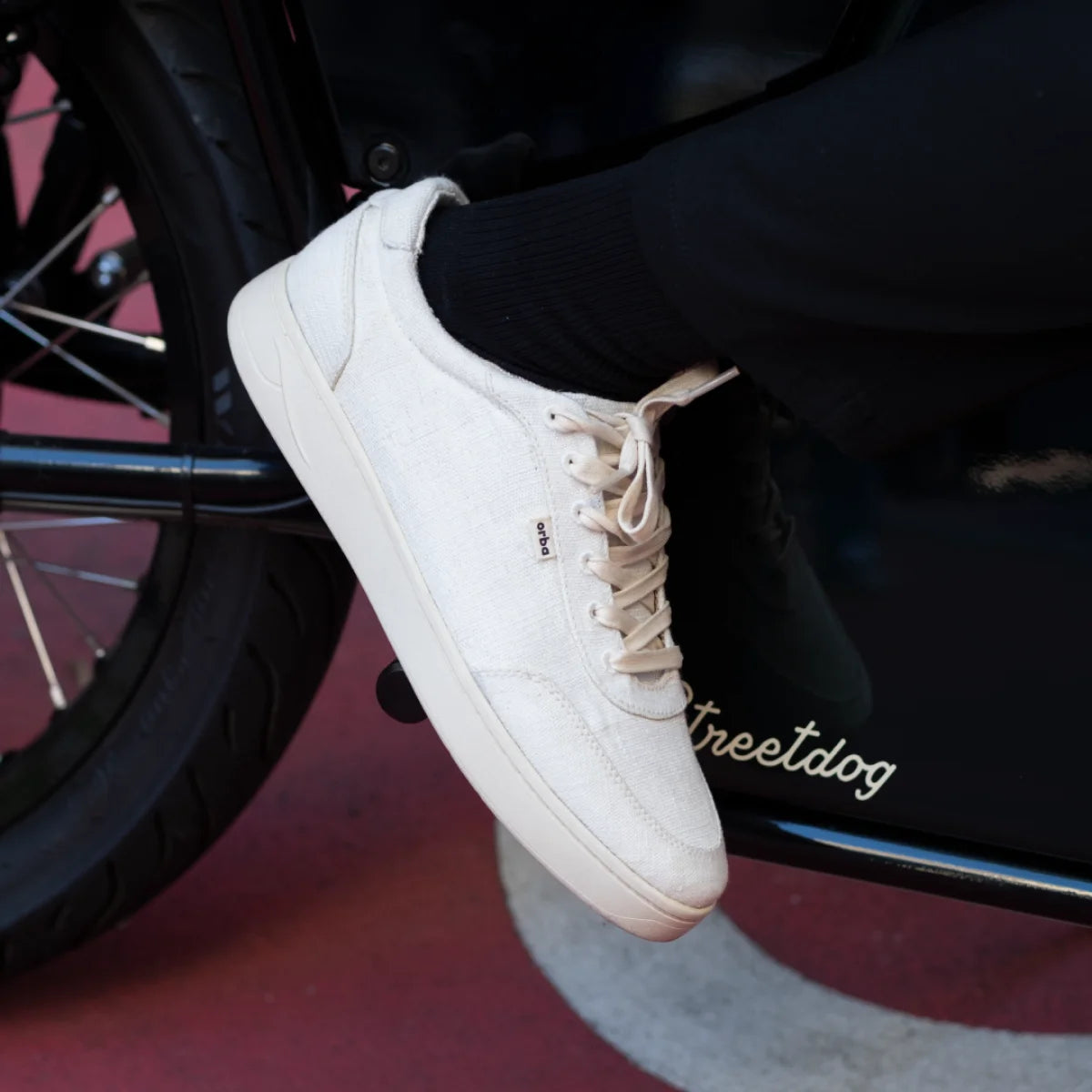 Man wearing Orba Ghost Sneakers on motorbike