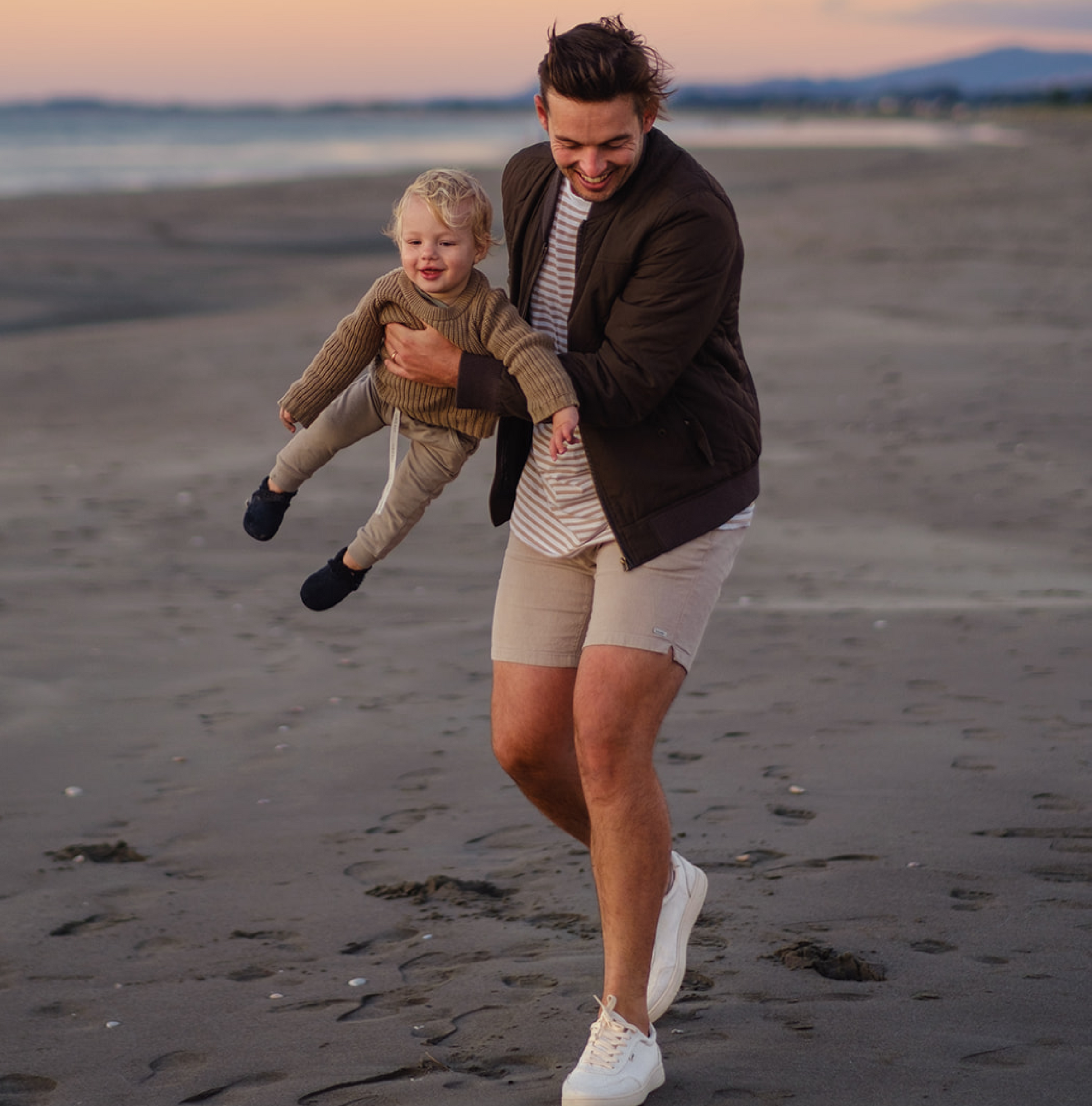 Father carrying child wearing Orba Ghost sneakers